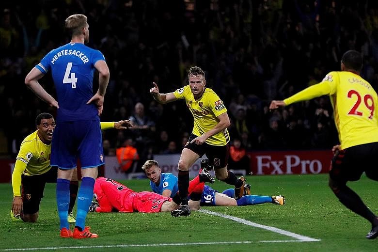 Watford's Tom Cleverley (centre) wheeling away in delight after his extra-time winner condemned Arsenal to their third loss of the campaign. The Gunners have registered only one league point on their travels so far this term.