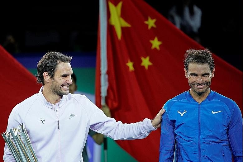 Roger Federer sharing a laugh with Rafael Nadal after the Shanghai Masters final. He can still end the season as the world No. 1.