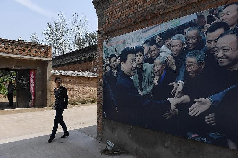 A billboard image of Chinese President Xi Jinping greeting residents in Zhangzhuang village, Lankao, in China's central Henan province. Mr Xi, who is General Secretary of the CCP, will open the 19th party congress on Wednesday.