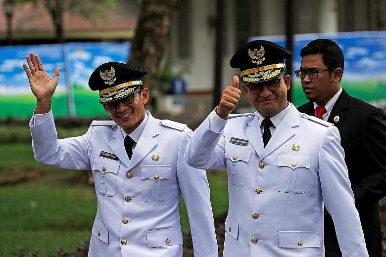 Jakarta governor Anies Baswedan (right) and his deputy Sandiaga Uno at the Presidential Palace in Jakarta yesterday.