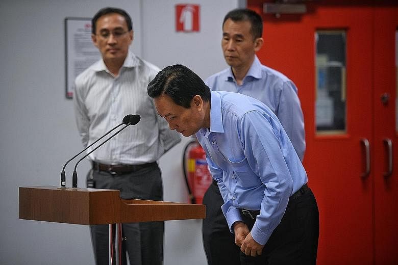 SMRT and SMRT Trains chairman Seah Moon Ming bowing as he apologised to commuters yesterday for the Oct 7 MRT flooding incident that disrupted service on the North-South Line for 20 hours. With him were SMRT group chief executive Desmond Kuek (left) 