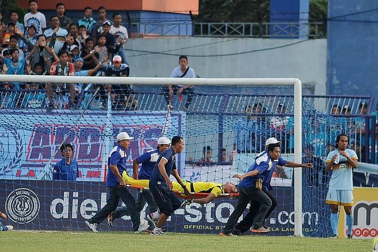 Medical staff rush the stricken Choirul Huda off the pitch on a stretcher after the Persela goalkeeper was injured in a mid-match collision with his team-mate, Brazilian midfielder Ramon Rodrigues, at Surajaya Lamongan stadium in Surabaya, East Java.