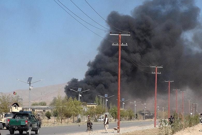 Afghan security forces keeping watch after suicide car bombers and gunmen attacked the provincial police headquarters in Gardez, the capital of Paktia province, in Afghanistan yesterday.