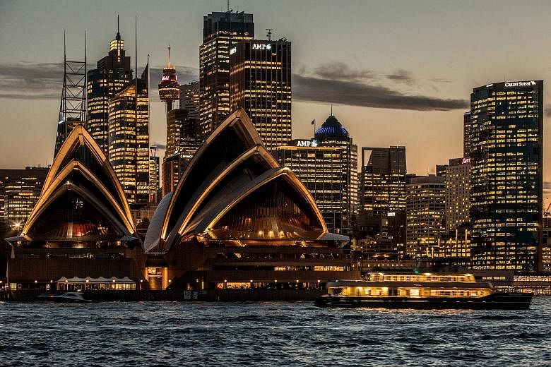 The Sydney Opera House and the city's financial district lit up at dusk. Power shortages and spiralling energy prices in some Australian states have led to growing anger particularly over the fact that the country is a major energy exporter.