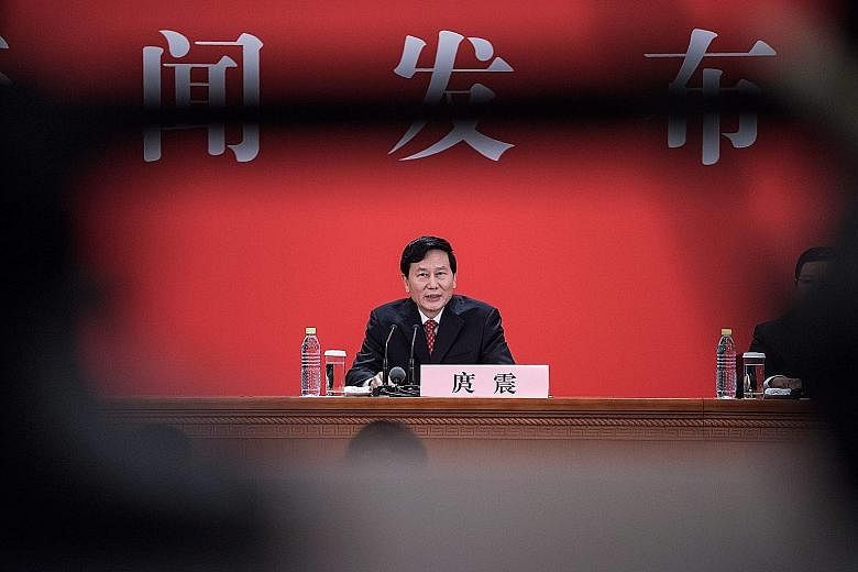CCP spokesman Tuo Zhen speaking on China's debt at a press conference yesterday, the eve of the opening of the 19th national party congress.