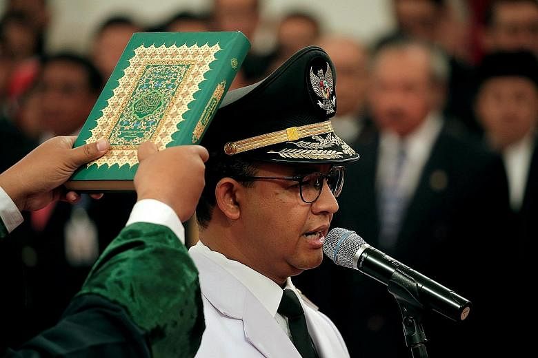 Governor Anies Baswedan at the swearing-in ceremony at the Presidential Palace in Jakarta on Monday. His inauguration speech prompted some people to accuse him of trying to stoke hatred against minorities again.