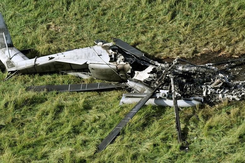 A wrecked US CH-53E transport helicopter in Okinawa last week. The US military said the blaze occurred after the aircraft had landed in the field and no crew were injured.