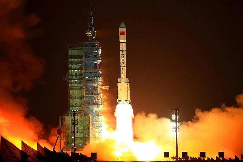 A rocket carrying the Tiangong-1 blasting off from the Jiuquan launch centre in Gansu province on Sept 29, 2011. In May, China told the UN that the lab would re-enter Earth between October and next April.