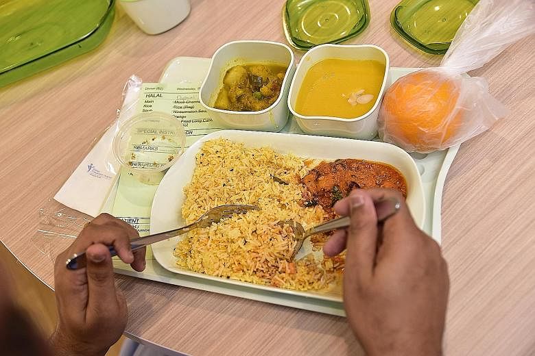 Mr Vungaralu Rajendraprasad Pandurangan being served his Deepavali dinner yesterday. It came with a main course of baked chicken tikka and carrot rice flavoured with herbs to resemble briyani. There was also curried pumpkin soup without cream or coco