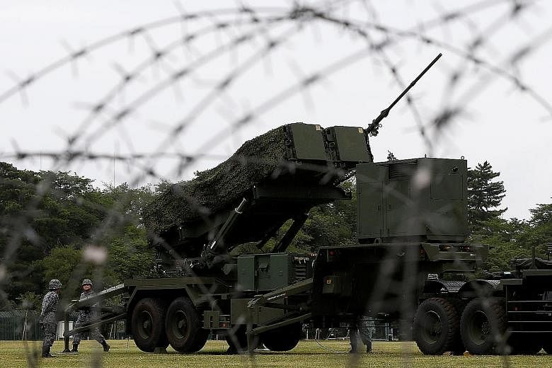Japanese soldiers holding a drill to mobilise their Patriot Advanced Capability-3 missile unit, in response to missile launches by North Korea, at Asaka base north of Tokyo. It's not just a matter of building the "bomb" - Japan would have to build up