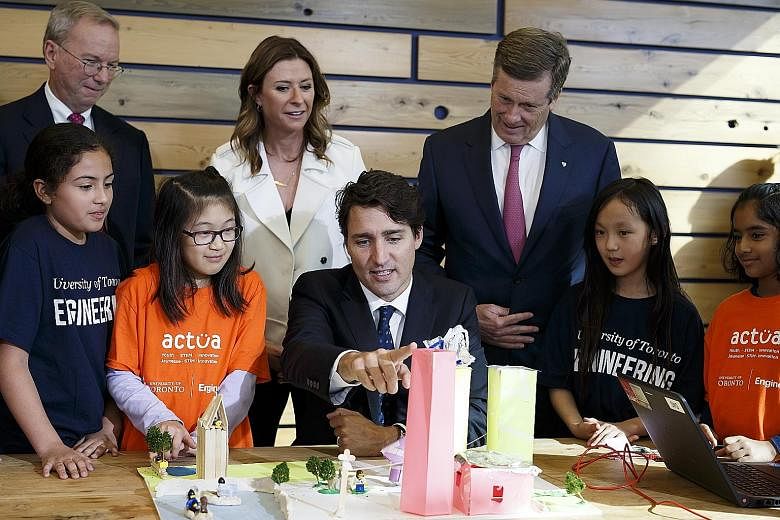 Canadian Prime Minister Justin Trudeau, Toronto Mayor John Tory (right) and chief executive officer of Alphabet Eric Schmidt viewing 3D city models built by children during an event in Toronto, Ontario, Canada, on Tuesday. Sidewalk Labs, the urban in