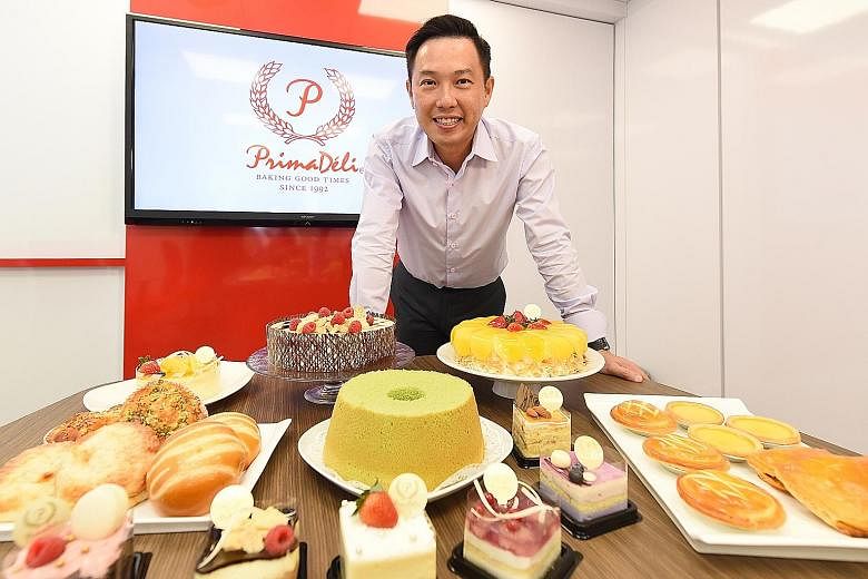 PrimaDeli general manager George Lim with some of the products made by the firm that are sold by its franchisees. The company's franchise model differed from others in that the idea was for existing bakeries to take on the PrimaDeli brand and sell pr
