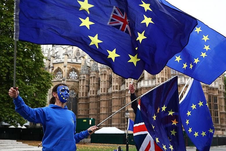 A pro-EU protest outside the Houses of Parliament in London on Tuesday. Some observers in the British capital are now arguing that, instead of seeking to avert it, an actual breakdown in the talks may potentially be the only way out of the current im