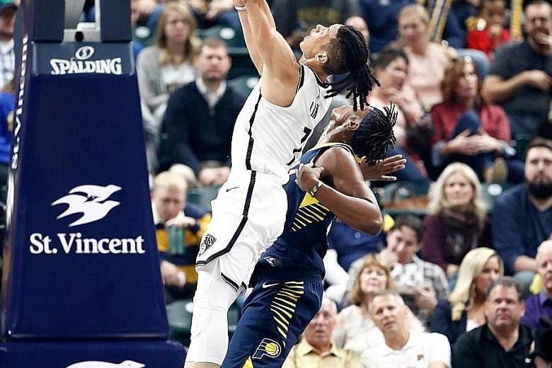 Left: Brooklyn Nets guard Jeremy Lin going for a lay-up at the Indiana Pacers on Wednesday. The Asian-American star suffered a serious non-contact injury while driving to the basket. pick last year, but had to sit out last season with a broken foot.