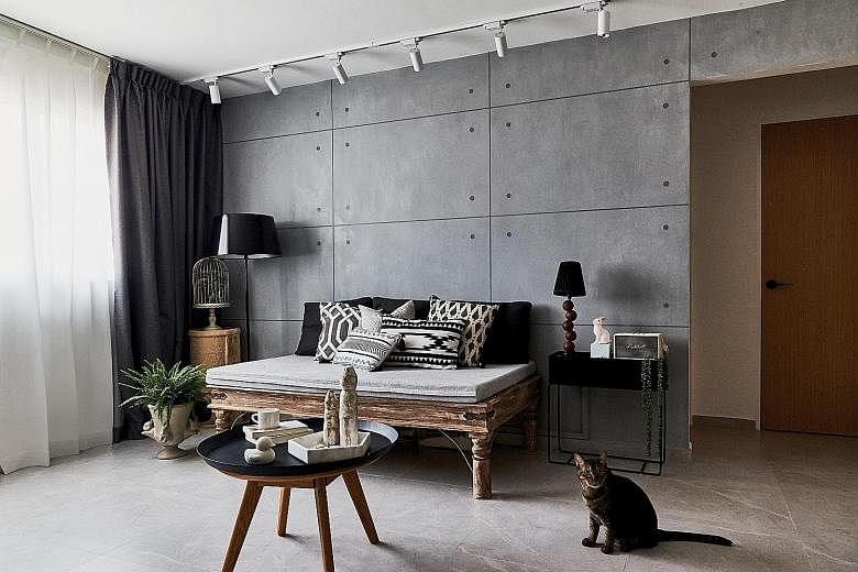 Concrete-looking tiles create a cement screed-vibe in the living room, which has a sofa the owner bought from fashion retailer British India.