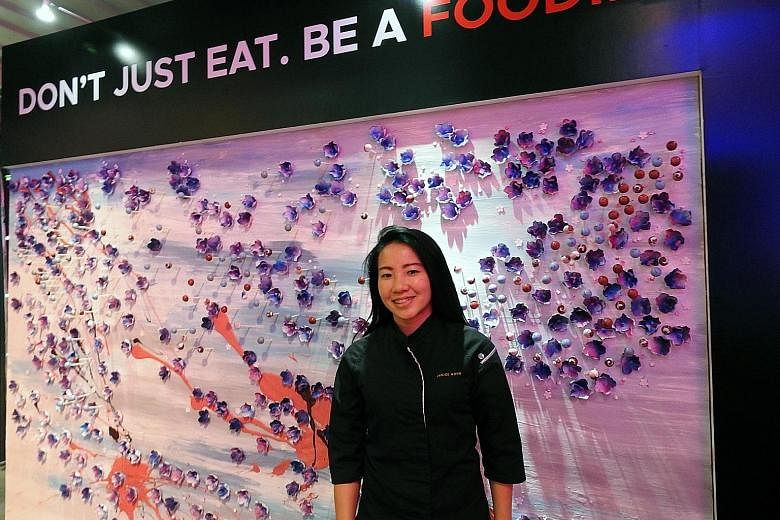 Singapore pastry chef Janice Wong with her dessert art wall showcasing the Republic's flora and fauna at the launch of the new STB brand campaign in Seoul yesterday. The wall features orchid-shaped sugar flowers and chocolate balls infused with gula 