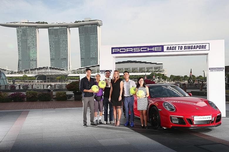 From left: Straits Times readers Davy Sanh, Bernard Lau, Justin Tan, Sean Long and Natalie Ow won the chance to meet world No. 1 Simona Halep, the top player of this year's Porsche Race to Singapore, at a handover ceremony for the 911 GTS yesterday. 