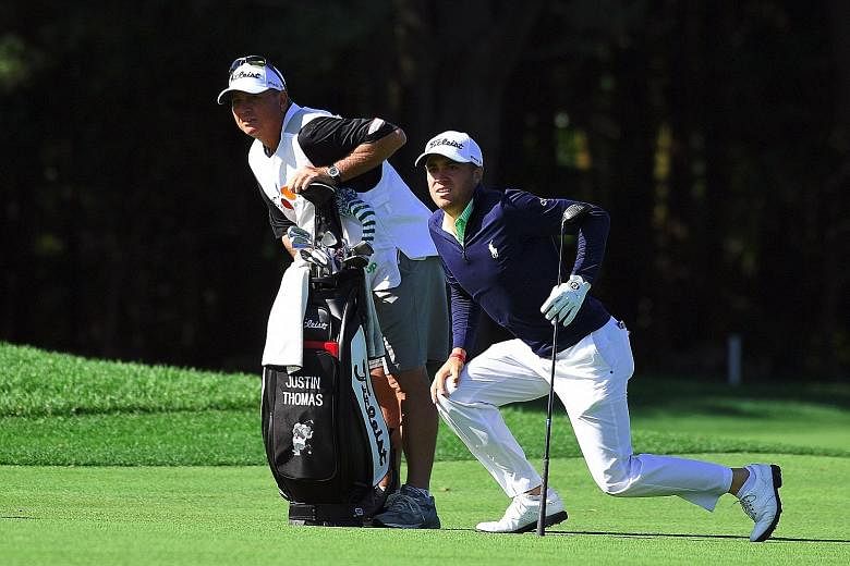 Above: American Justin Thomas and his caddie watching his second shot on the third hole during the second round of the CJ Cup at Nine Bridges in Jeju Island yesterday. Left: Luke List, ranked 138th in the world, is the surprise halfway leader on 135.
