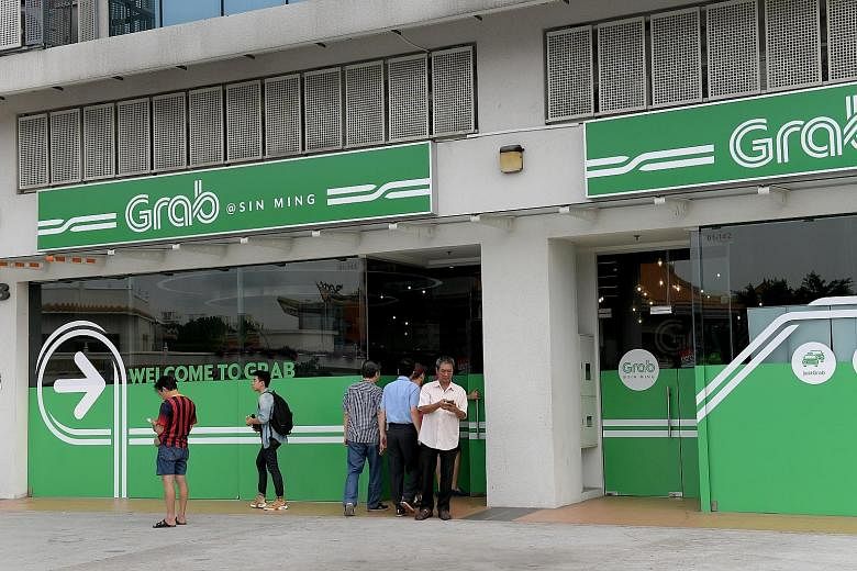 Grab said it will build the largest and most advanced taxi and private-hire car fleet in Singapore, with exclusive access to SMRT's entire network of taxis and Strides private-hire cars.