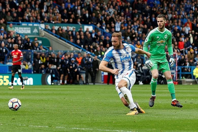 Huddersfield's Laurent Depoitre rounds Manchester United goalkeeper David de Gea to double his side's lead. The last time Huddersfield recorded a win over their illustrious opponents was in 1952.