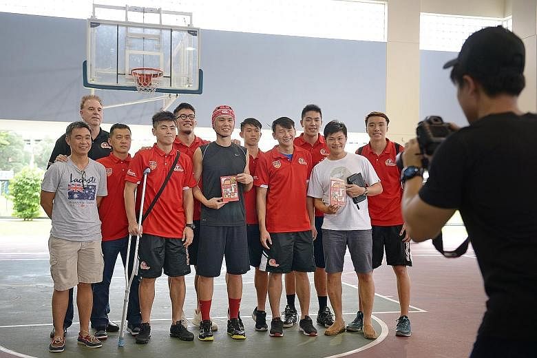 Former national basketballer Lim Wai Sian (centre, wearing rugby cap) launched his first book titled Rebound: LaoLao's Guide to Giving Up yesterday at his alma mater, the Presbyterian High School. He was joined by his former team-mates and coaches fr