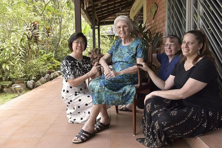 Reverend Dr Ernest Poulson was dean of Singapore Bible College for 30 years. He and his wife, along with two daughters, came to Singapore in 1953 and have stayed here since. Below: Mrs Verda Poulson, 91, with her (from left) god-daughter Koh Siang Ki