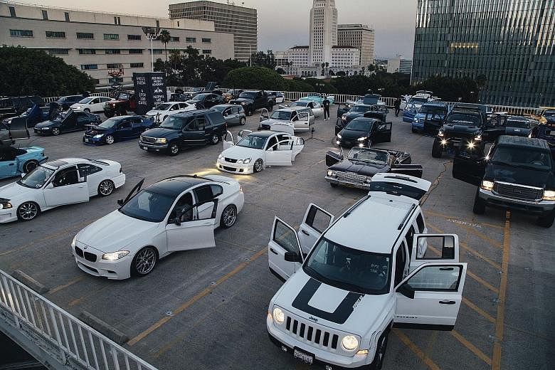 Cars gathered on the roof of a parking lot across the street from Frank Gehry's Walt Disney Hall to perform A (For 100 Cars), a composition by Ryoji Ikeda. Mr Edwin Hammond Meredith's 1978 Cadillac DeVille overheated during the performance and had to