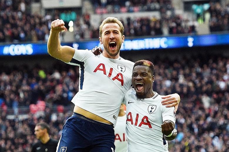 Tottenham's Harry Kane (left) celebrating his fourth-minute opener against Liverpool with Serge Aurier during their English Premier League match at Wembley yesterday. It was the England striker's first Premier League goal at Wembley for Spurs, who wo