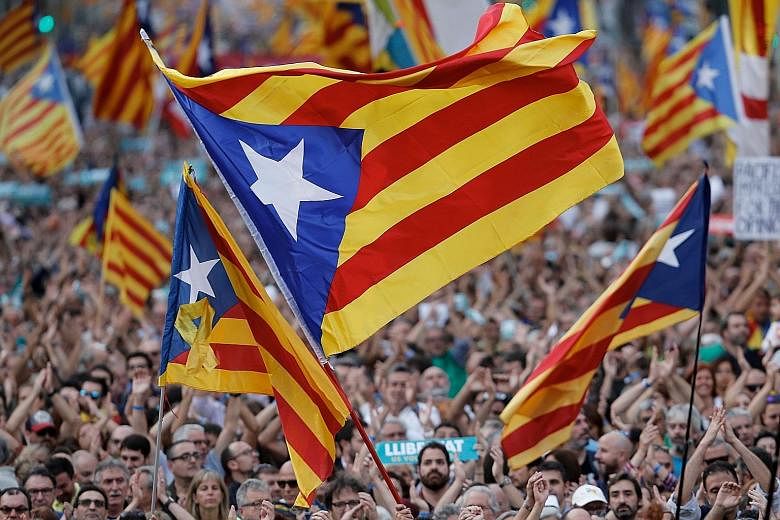 Protesters waving pro-independence Catalan Estelada flags in Barcelona on Saturday. Catalan government spokesman Jordi Turull says there has been a full-fledged coup against the region's institutions.