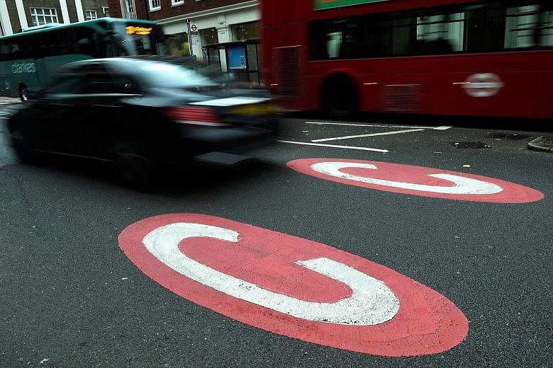 Road markings signalling the start of the congestion charge area in central London. Those driving petrol and diesel vehicles typically registered before 2006 will need to pay an additional charge on top of the congestion charge of £11.50 (S$20.65).