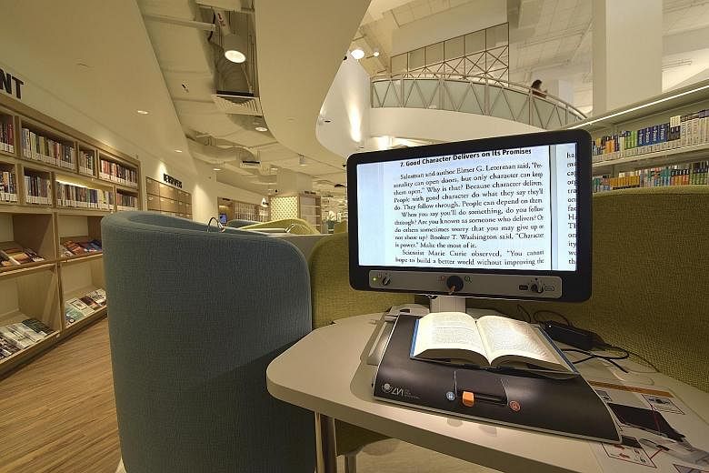 The Bedok Public Library, which will re-open on Saturday at Heartbeat @Bedok, has elder-friendly features, such as this document magnifier. When a book is placed on it, the text on the opened page is enlarged on the screen.
