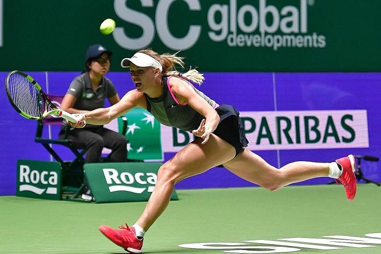 Former world No. 1 Caroline Wozniacki stretching to return a shot from Elina Svitolina in their WTA Finals match last night. The Dane easily won 6-2, 6-0 for her first victory over the Ukrainian.