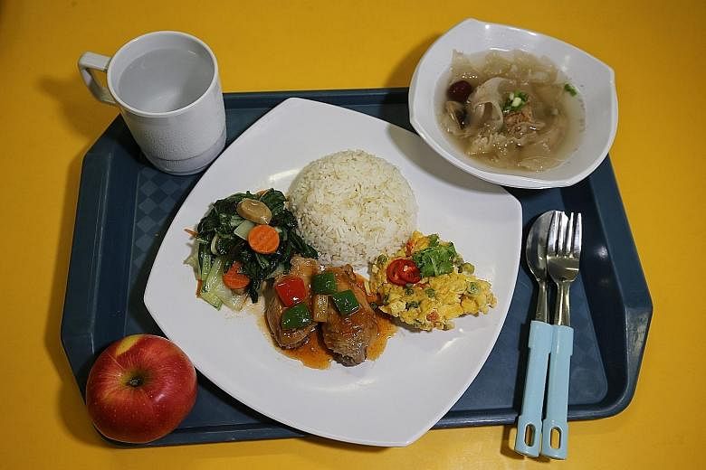 Above: Cookhouse food from a commercial vendor at Kranji Camp III. Above, left: A lower-calorie meal with less rice and one less meat serving.