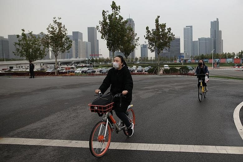 Cyclists wearing face masks in Tianjin last week. The average PM2.5 reading for China's capital region, which includes Beijing and Tianjin, climbed 10.2 per cent from a year earlier.
