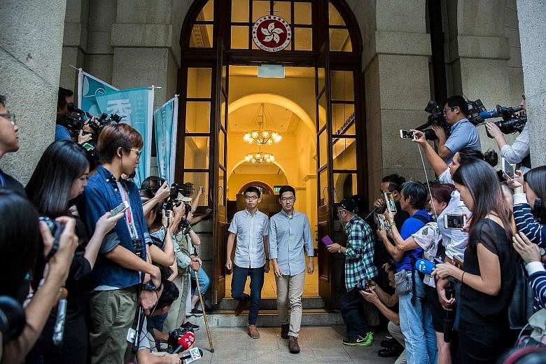 Activists Joshua Wong (left) and Nathan Law leaving Hong Kong's Court of Final Appeal yesterday, after succeeding in their bail applications. They were jailed for their roles in the 2014 Umbrella Movement.
