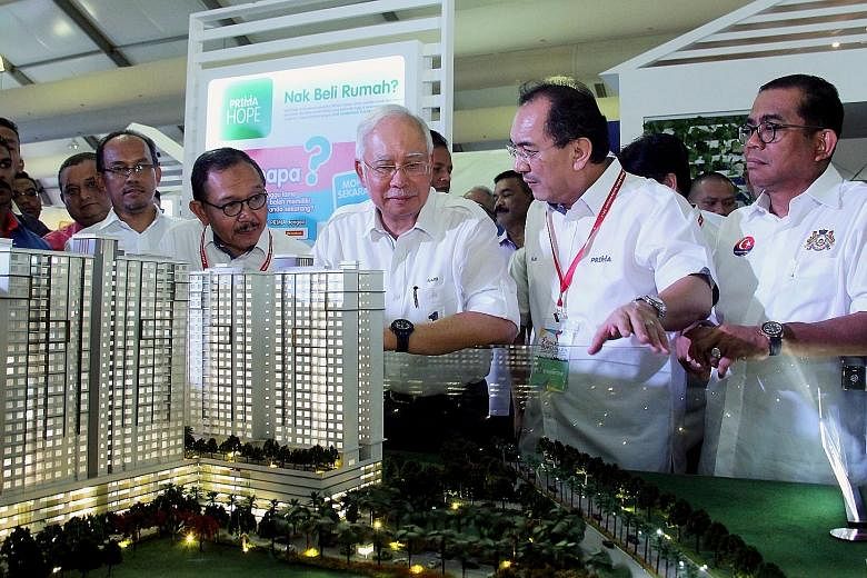 Malaysian Prime Minister Najib Razak (third from right) visiting the showroom of affordable housing project PR1MA in Kota Iskandar. Malaysia's central bank said in July that home ownership is still seriously unaffordable.
