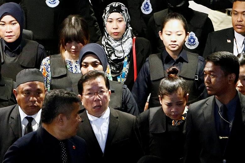 The accused - Indonesian Siti Aisyah (front, second from right) and Vietnamese Doan Thi Huong (back, second from far left) - being escorted as they and the rest of the court visited the Kuala Lumpur International Airport 2 yesterday.