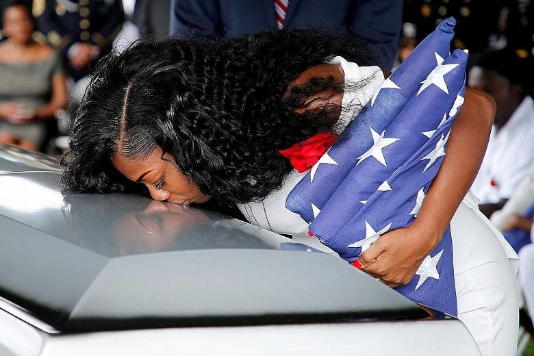 Ms Myeshia Johnson, wife of US Army Sergeant La David Johnson (above), who was among four special forces soldiers killed in Niger, kissing his coffin at a service in Florida last Saturday.