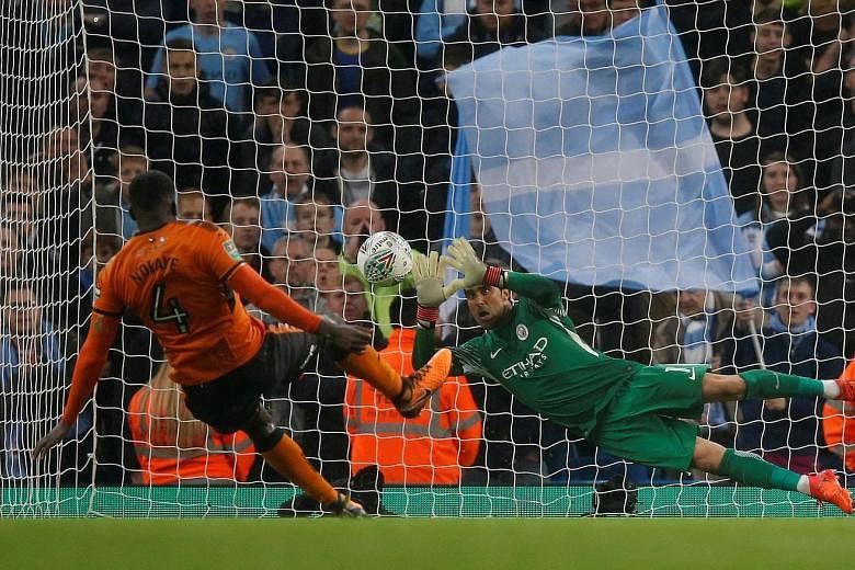 Manchester City's Chilean custodian Claudio Bravo saving Wolves midfielder Alfred N'Diaye's penalty in the shoot-out that City won 4-1. A squirrel running onto the pitch before kick-off was one of the game's few high points.