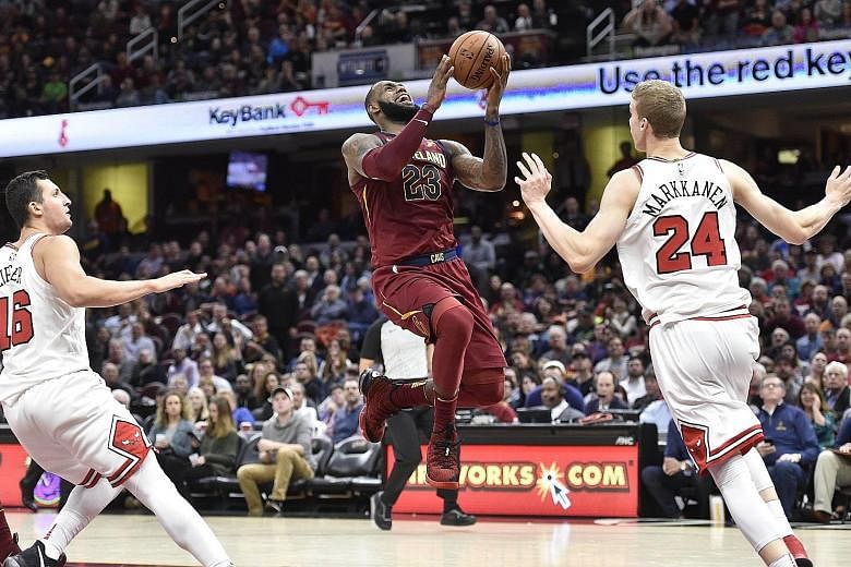 Cleveland forward LeBron James driving to the basket as Chicago forward Lauri Markkanen tries to blocks him. Moved from forward to point guard for the first time in five years, James scored 34 points and had 13 assists in the Cavs' 119-112 win.
