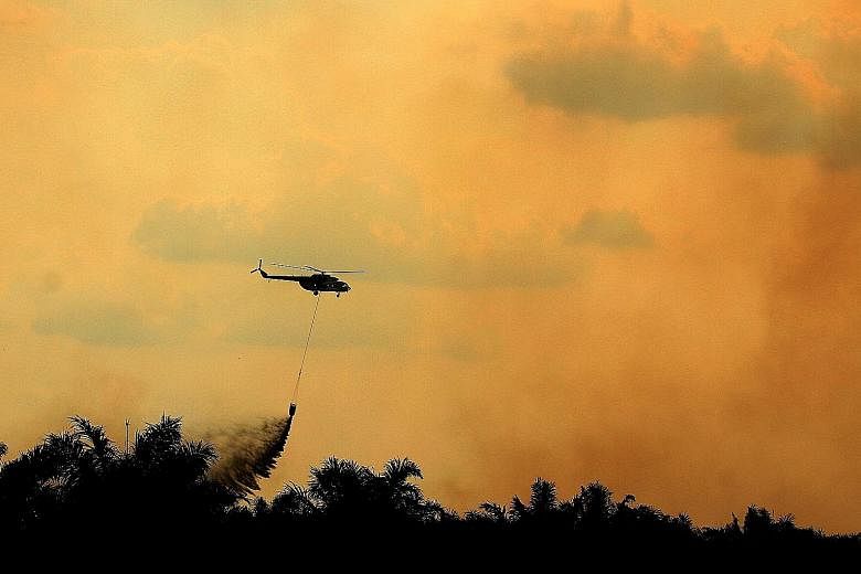 A helicopter operated by the Indonesian National Disaster Management Agency conducting water bombing operations to put out fires in Ogan Ilir, South Sumatra, in August.