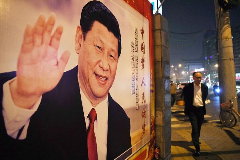 A poster of Chinese President Xi Jinping in Beijing. Mr Xi had conspicuously left out any mention of a gross domestic product target in his work report.
