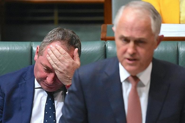 Australia's Deputy Prime Minister Barnaby Joyce, seen here seated behind Prime Minister Malcolm Turnbull in the House of Representatives at Parliament House in Canberra on Tuesday, was found by the High Court to be ineligible to be an MP as he was a 