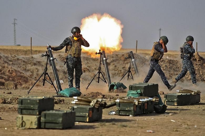 Iraqi forces firing mortars on the Kurdish Peshmerga near the area of Faysh Khabur, on the Turkish and Syrian borders, in the Kurdish autonomous region on Thursday.