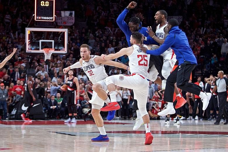 LA Clippers forward Blake Griffin (left) celebrating after his game-winning three-point basket against the Portland Trail Blazers just before time expired on Thursday. The Clippers improved to 4-0.