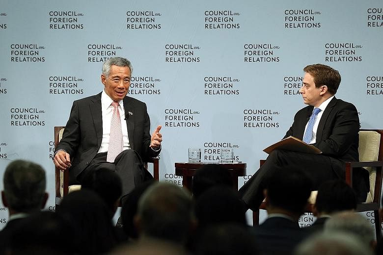 Prime Minister Lee Hsien Loong at the dialogue at the Council on Foreign Relations on Wednesday, with moderator Evan Osnos. Mr Lee said that the United States has to work out its relationship with a bigger and stronger China not just on bilateral iss