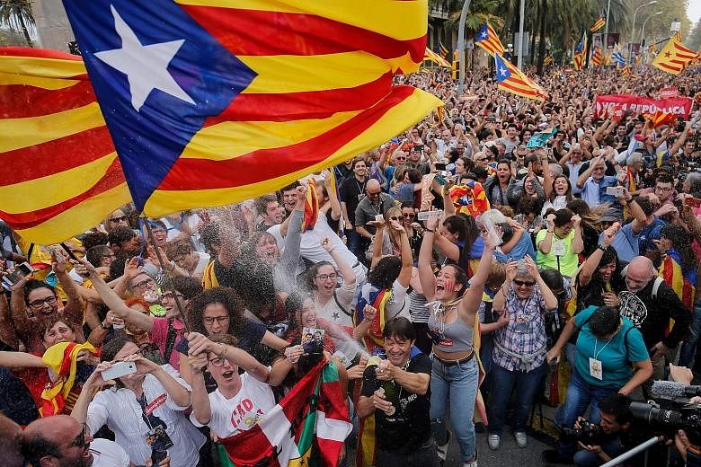 People celebrating in Barcelona yesterday after Catalonia's Parliament voted to declare independence from Spain, despite a walkout by opposition MPs who refused to consider the resolution.
