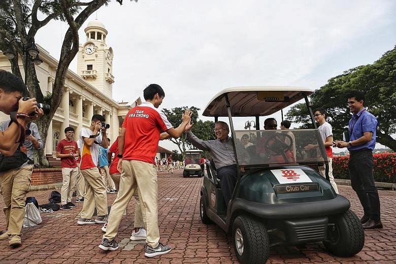 Hwa Chong Institution students and staff saying goodbye to outgoing principal Hon Chiew Weng yesterday. Student council president Gui Ming Jiang says they will miss seeing him drive his buggy across the school grounds.