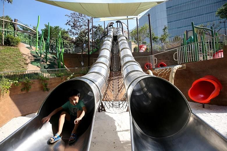 A young visitor trying out Singapore's longest and tallest tube slide in a public park. National Parks Board said it made use of the area's undulating terrain to come up with unique designs.