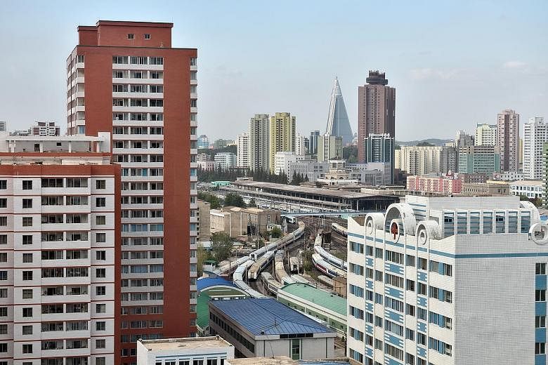 Far left: The red apartment blocks, containing the largest flats in the country, house the scientists from Pyongyang's Kim Chaek University of Technology. In the background is the pyramid-shaped Ryugyong Hotel. Left: The Sci Tech Park is being used t